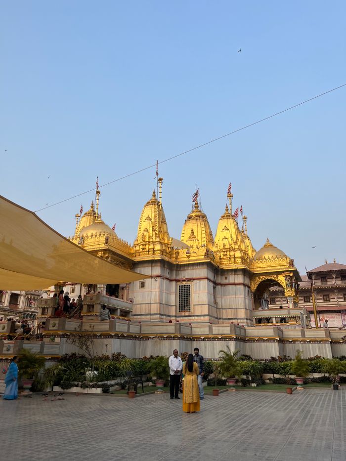 Stunning view of the golden temple in Vadtal, Gujarat, India during daytime.